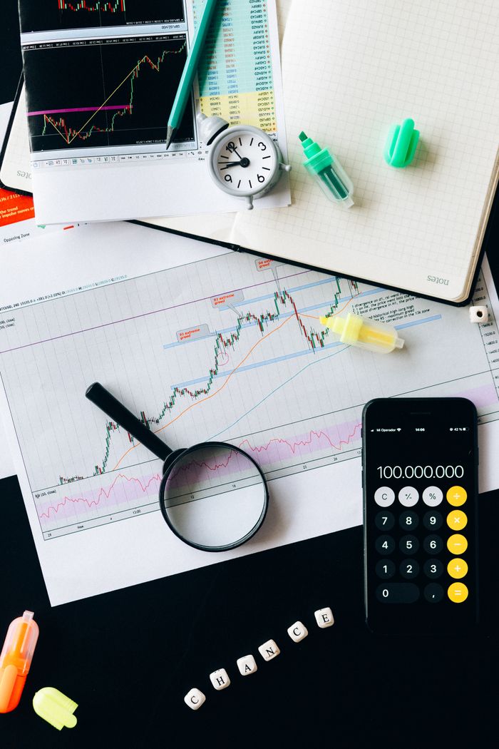 services-04 Stock market analysis setup with graphs, calculator, and magnifying glass.